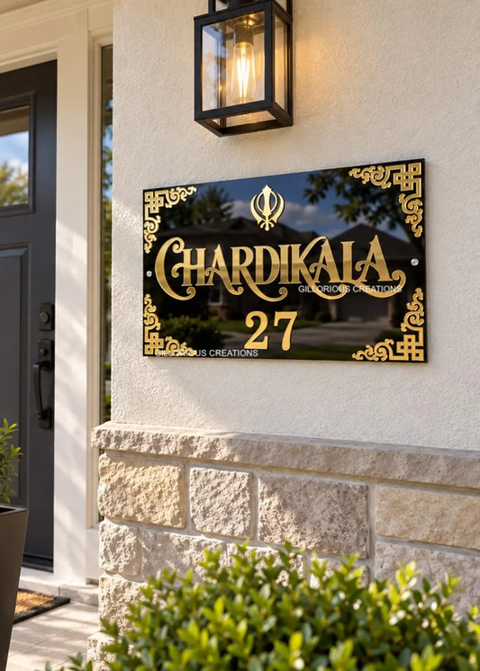 Chardi Kala glossy black acrylic Sikh house number sign with gold 3D Khanda Sahib and number 27 outside a home